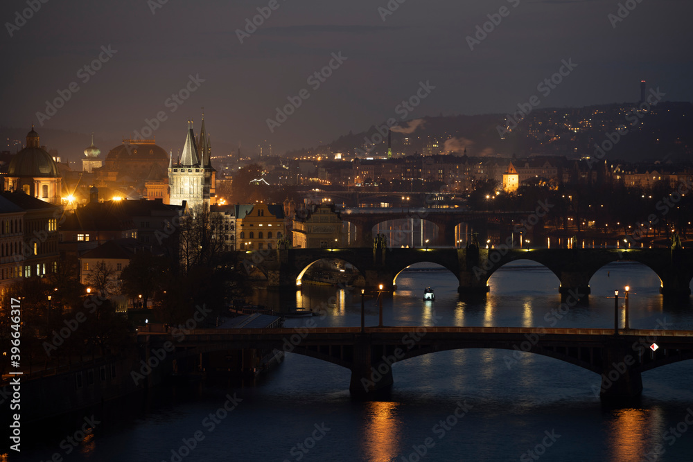 Fototapeta premium night view of the Vltava river and the bridges on it between the bridges and the Charles Bridge and the surrounding architecture and light from the street lights in the center of Prague after sunset
