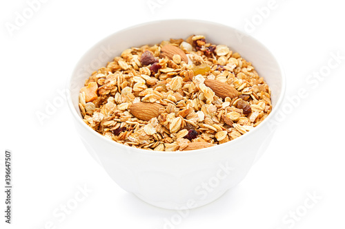 Tasty granola in bowl on white background