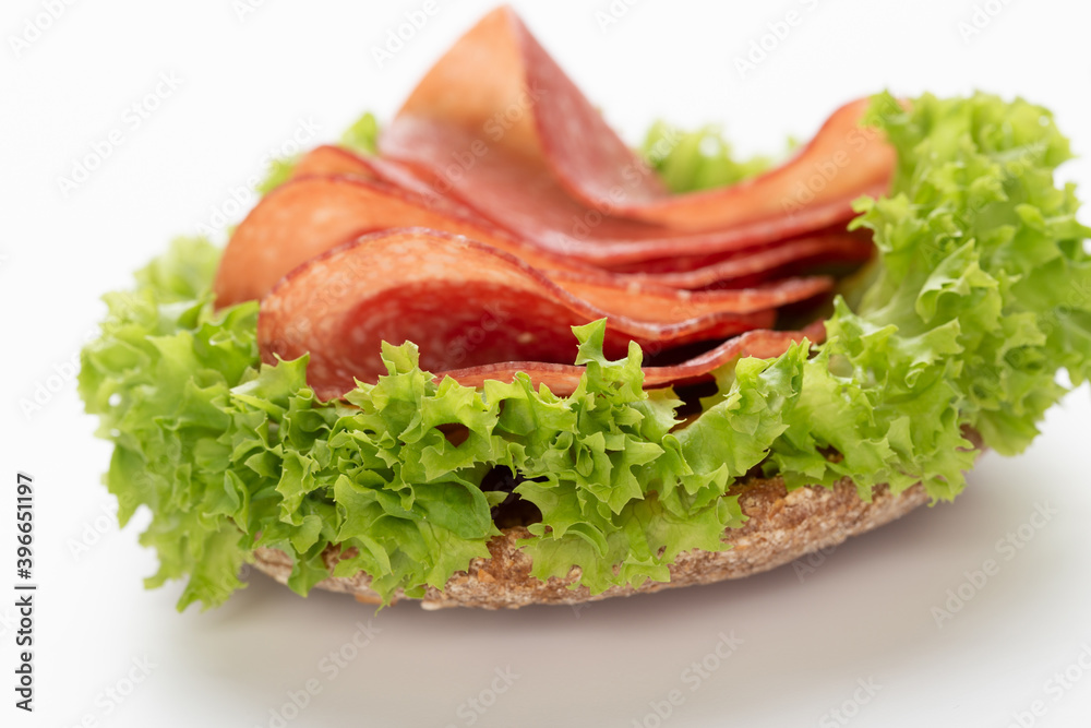 Sandwich with salami sausage on white background. Sandwich with salami sausage on white background.