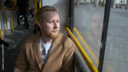 Wallpaper Mural stylish man rides a tram by the window Torontodigital.ca