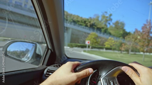 Wallpaper Mural First-person view of a man driving a car moving around the city. sun glare. Torontodigital.ca