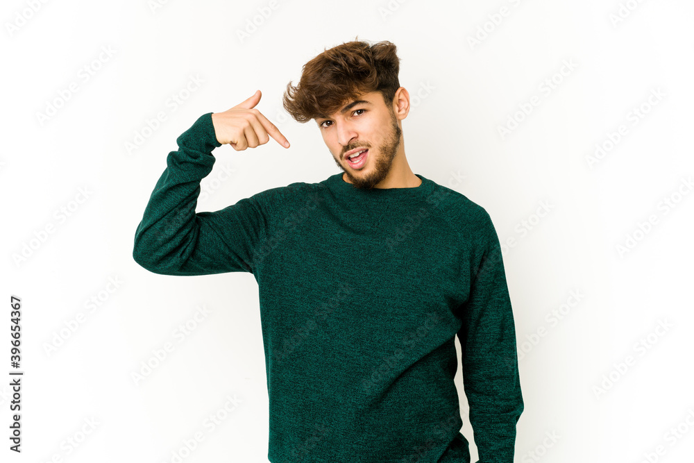 Young arab man on white background person pointing by hand to a shirt copy space, proud and confident Young arab man on white background person pointing by hand to a shirt copy space, proud and confident
