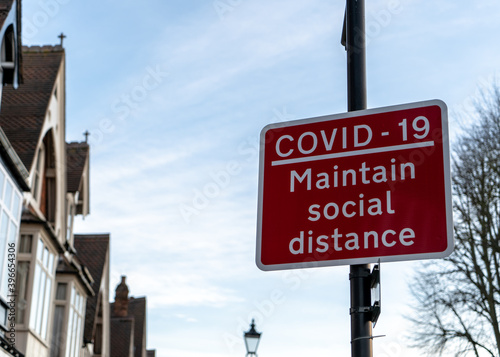 Solihull, United Kingdom - December 1 2020: Covid-19 'Maintain Social Distance' signpost after UK government announce tier system
