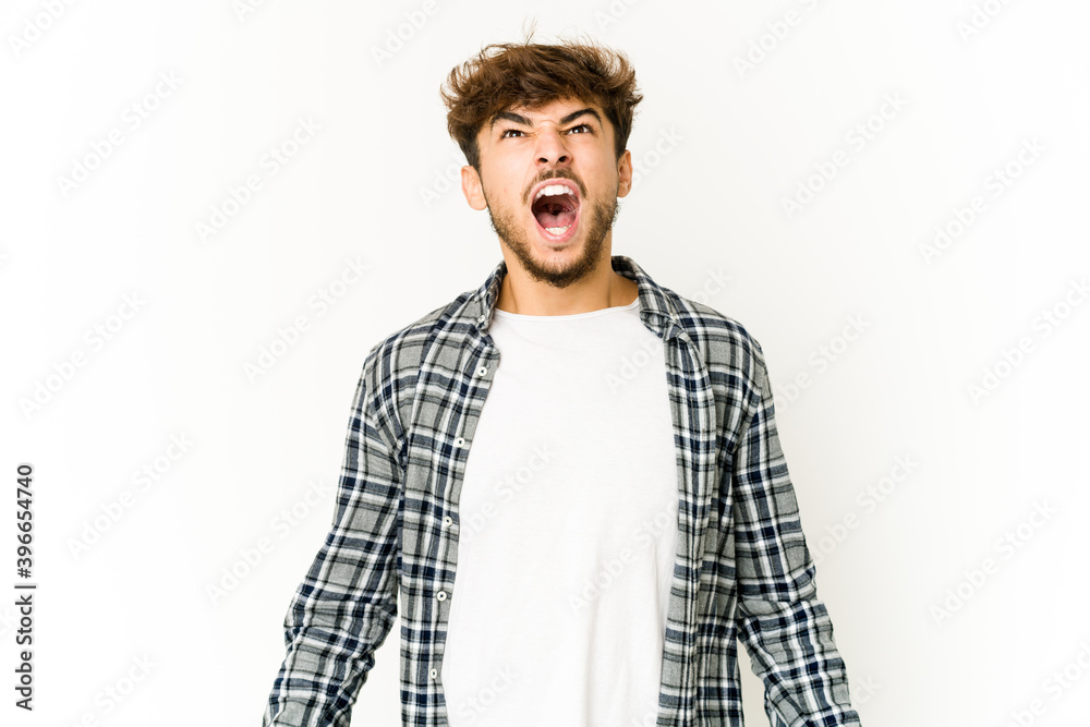 Young arab man on white background shouting very angry, rage concept, frustrated. Young arab man on white background shouting very angry, rage concept, frustrated.