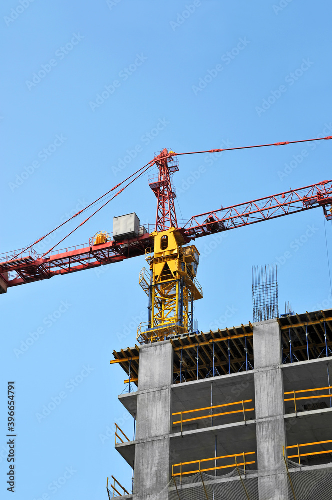 Crane and highrise construction site Crane and highrise construction site