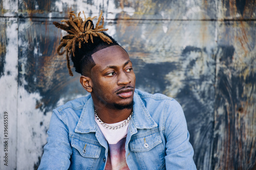Slika na platnu Handsome African-American Young man wearing a denim jacket with dreadlocks and f