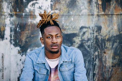 Valokuva Handsome African-American Young man wearing a denim jacket with dreadlocks and f