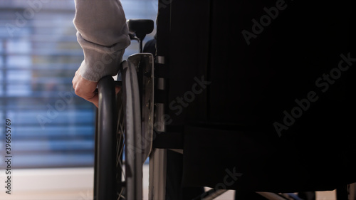 Close up of man on wheelchair at home in a living room.