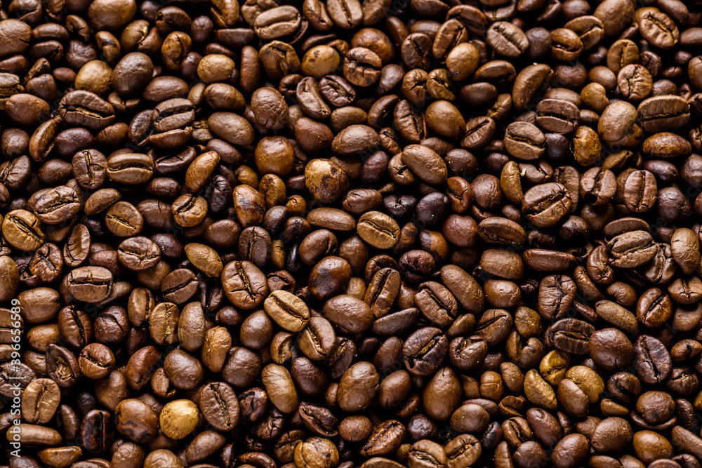 Fototapeta premium Fresh roasted coffee bean background. Background of roasted coffee beans, top view