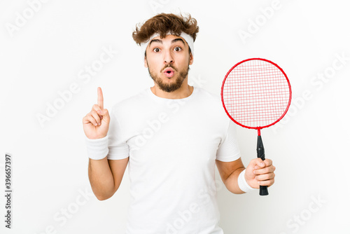 Young indian man playing badminton having some great idea, concept of creativity.