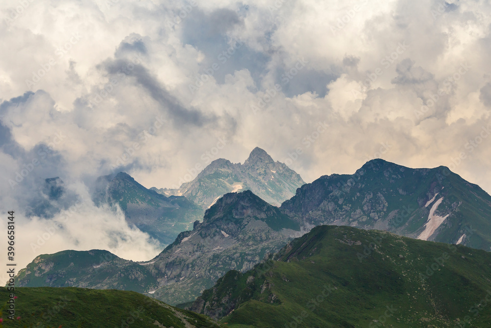 Beautiful mountain landscape at Caucasus mountains with clouds in the sky