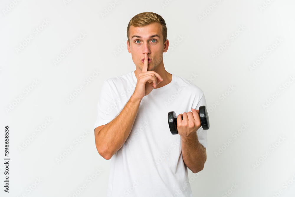 Young caucasian man holding a weight isolated on white background