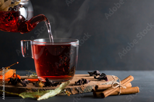 Fototapeta Winter herbs and spices tea in glass teapot or mug, alternative medicine for the