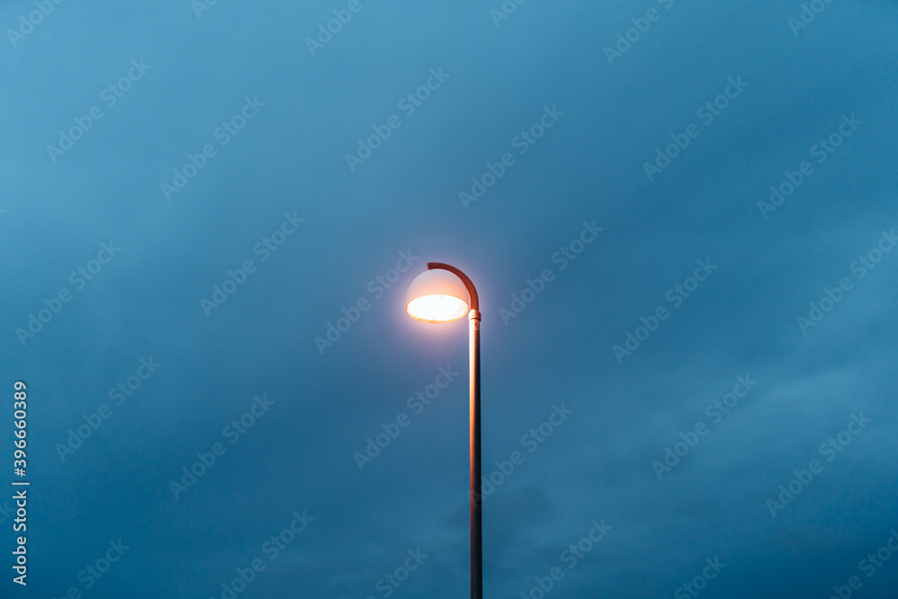 View of illuminated street light against blue sky View of illuminated street light against blue sky