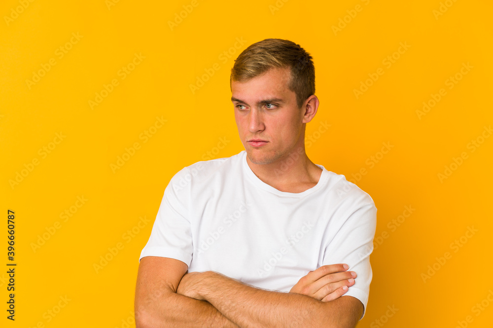 Young caucasian handsome man tired of a repetitive task.