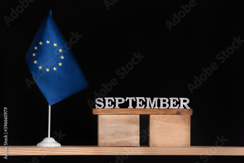 Wooden calendar of September with flag EU on black background. European Union Dates of September