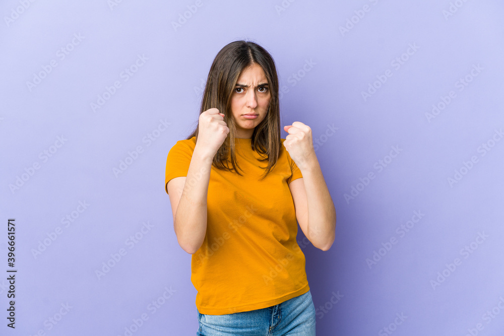 Young caucasian woman showing fist to camera, aggressive facial expression. Young caucasian woman showing fist to camera, aggressive facial expression.