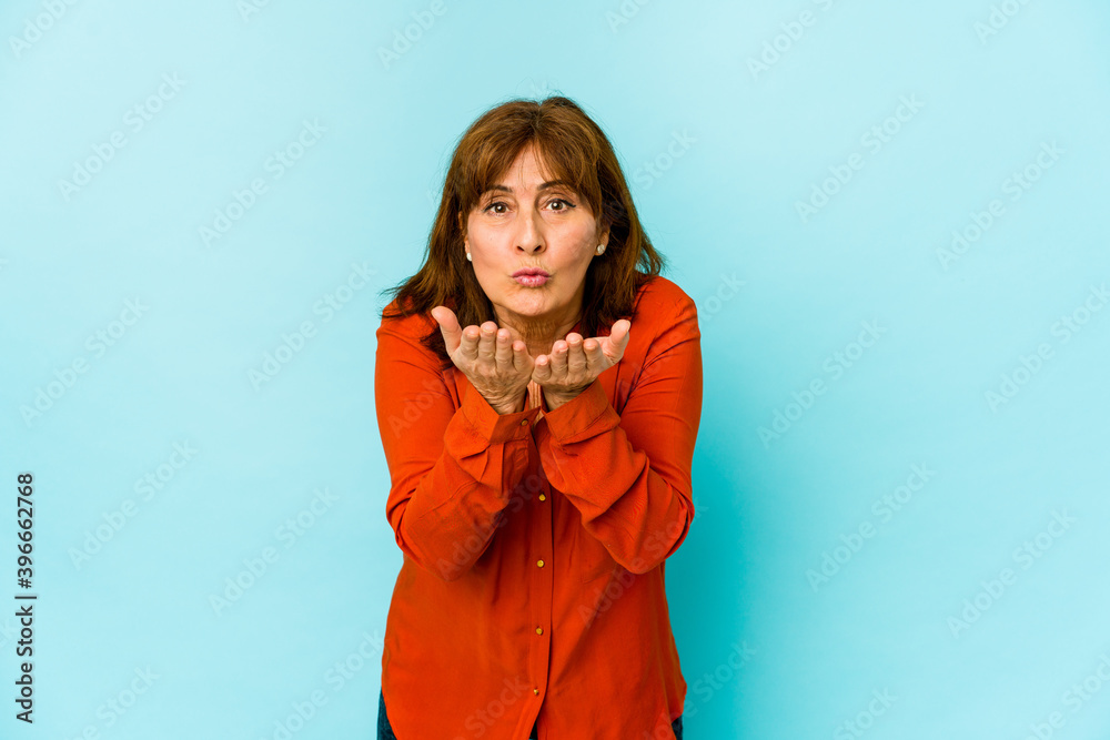 Senior caucasian woman isolated folding lips and holding palms to send air kiss. Senior caucasian woman isolated folding lips and holding palms to send air kiss.