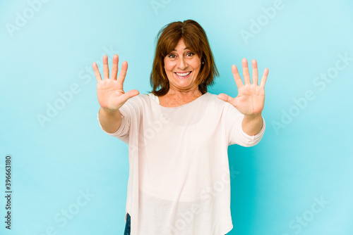 Senior caucasian woman isolated showing number ten with hands.