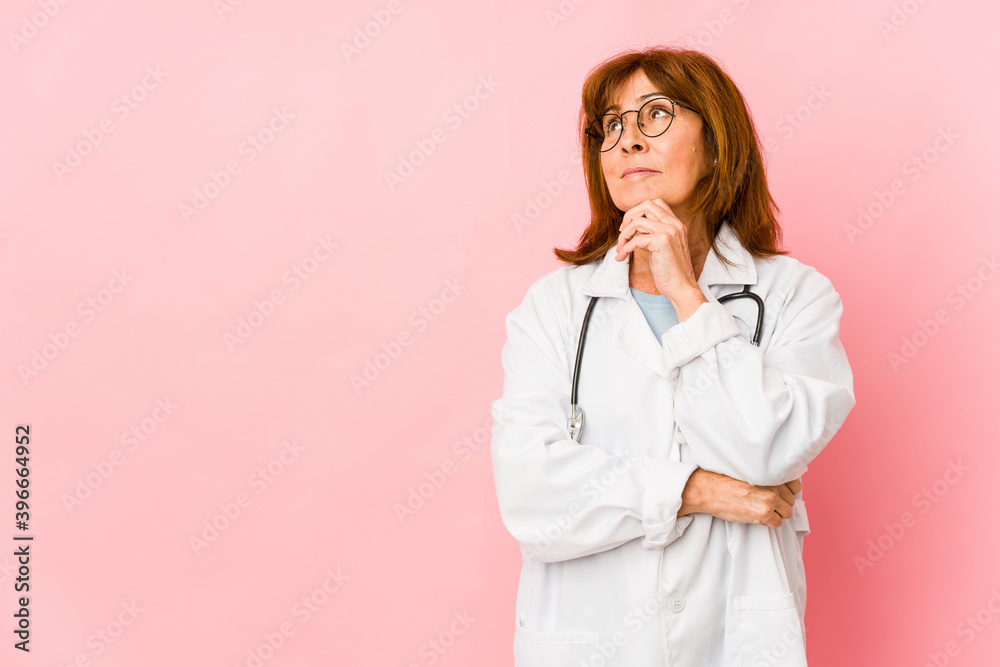 Middle age caucasian doctor woman isolated looking sideways with doubtful and skeptical expression. Middle age caucasian doctor woman isolated looking sideways with doubtful and skeptical expression.