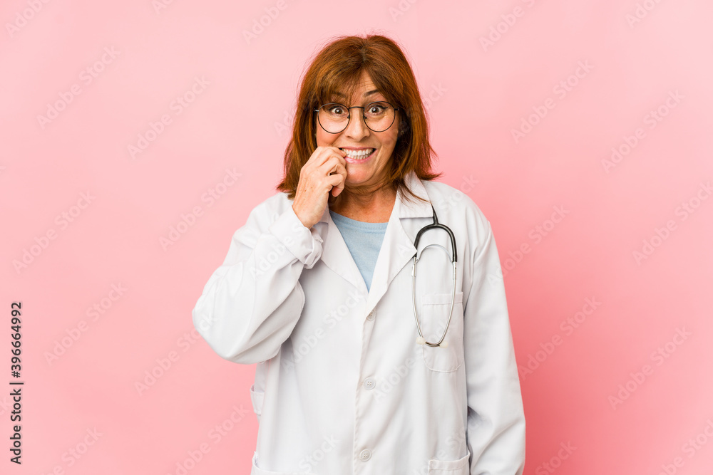 Middle age caucasian doctor woman isolated biting fingernails, nervous and very anxious. Middle age caucasian doctor woman isolated biting fingernails, nervous and very anxious.