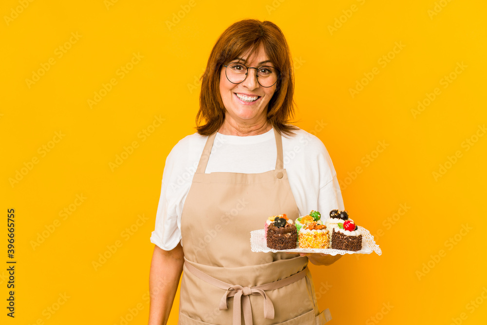 Middle age caucasian cook woman happy, smiling and cheerful. Middle age caucasian cook woman happy, smiling and cheerful.