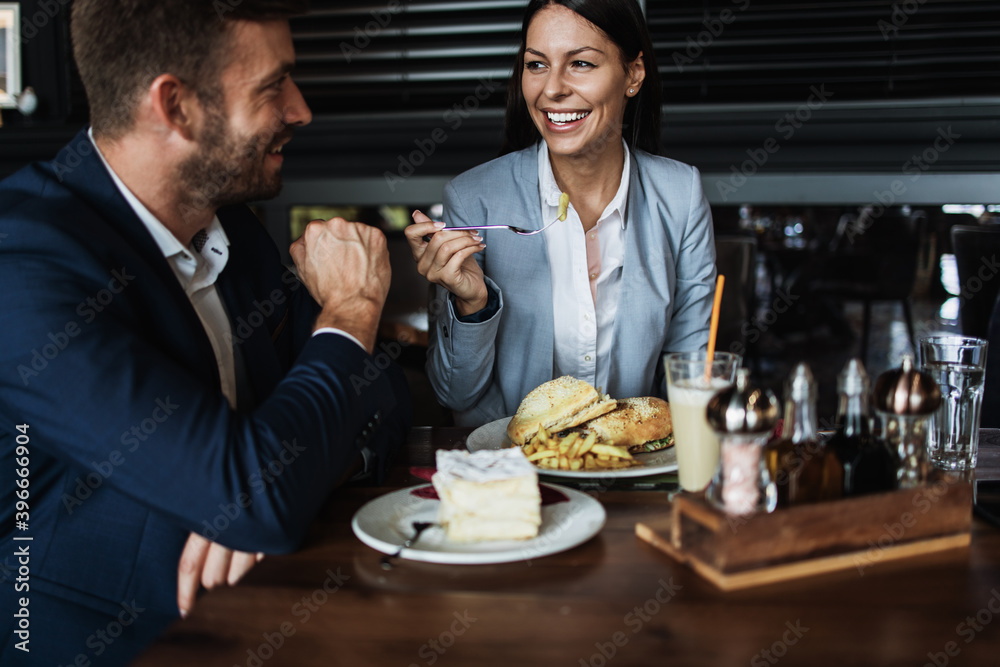 Happy couple man and woman sitting in modern cafe bar or restaurant and drinking coffee. Happy couple man and woman sitting in modern cafe bar or restaurant and drinking coffee.