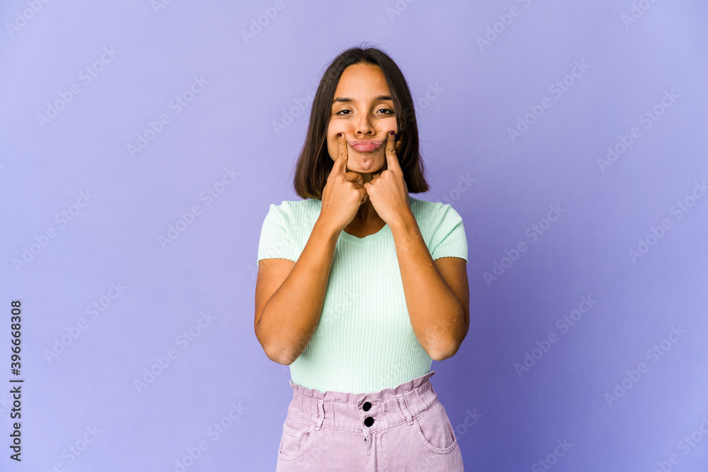 Young mixed race woman doubting between two options. Young mixed race woman doubting between two options.