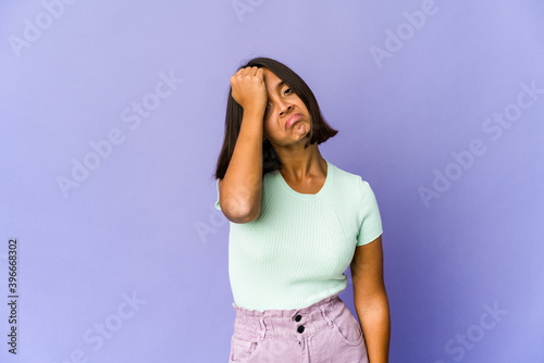 Young mixed race woman tired and very sleepy keeping hand on head. © Asier