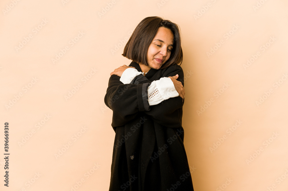 Young hispanic woman isolated hugs, smiling carefree and happy. Young hispanic woman isolated hugs, smiling carefree and happy.