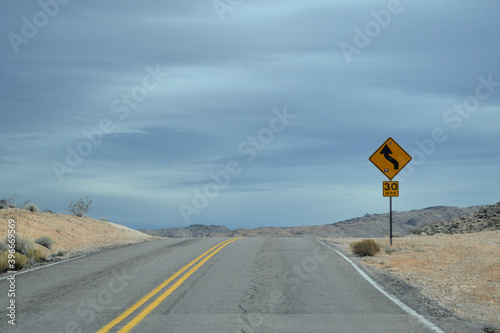 Road with yellow warning sign, Utah, US