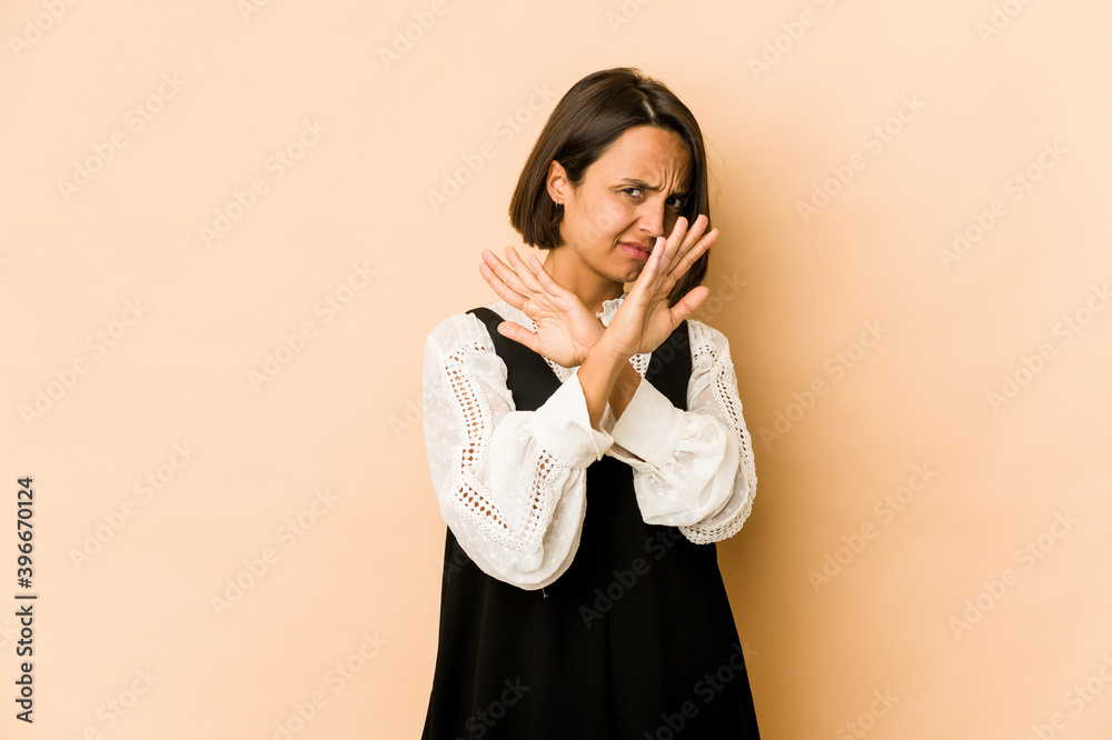 Young hispanic woman isolated keeping two arms crossed, denial concept. Young hispanic woman isolated keeping two arms crossed, denial concept.