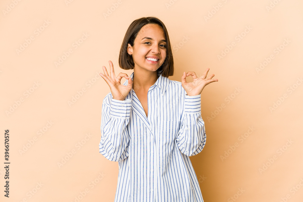 Young hispanic woman isolated cheerful and confident showing ok gesture. Young hispanic woman isolated cheerful and confident showing ok gesture.