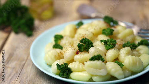 Selective focus. Macro. Gnocchi with olive oil and spices on a plate. A serving of gnocchi.