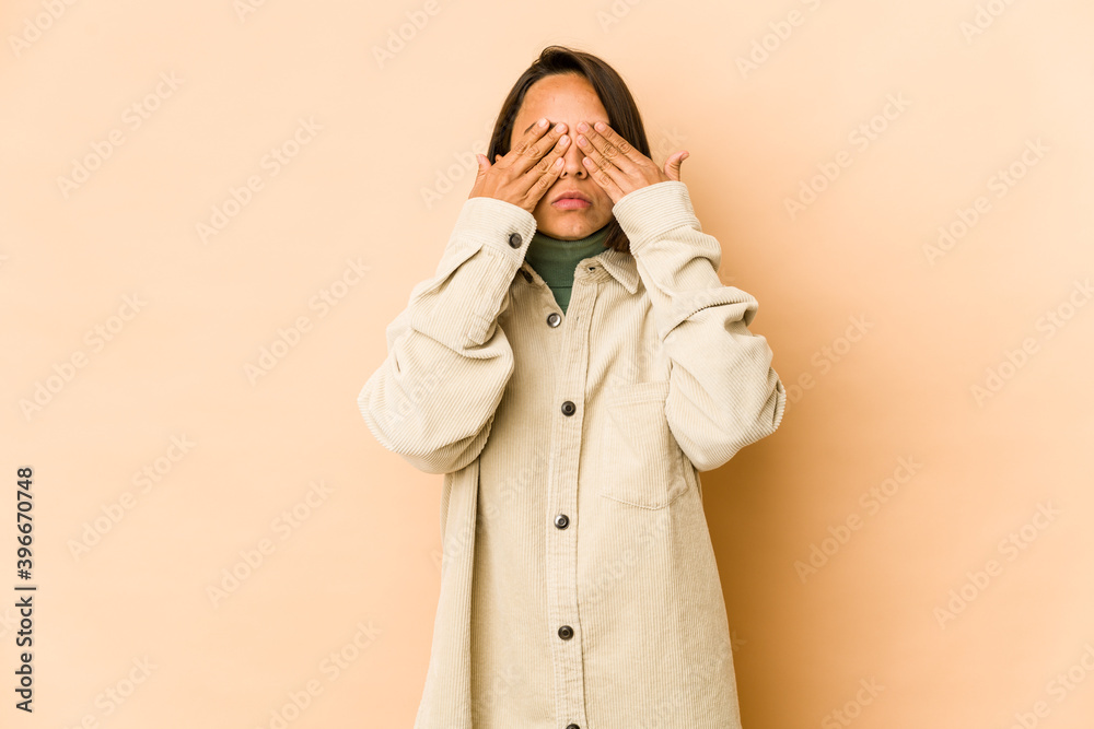 Young hispanic woman isolated afraid covering eyes with hands. Young hispanic woman isolated afraid covering eyes with hands.