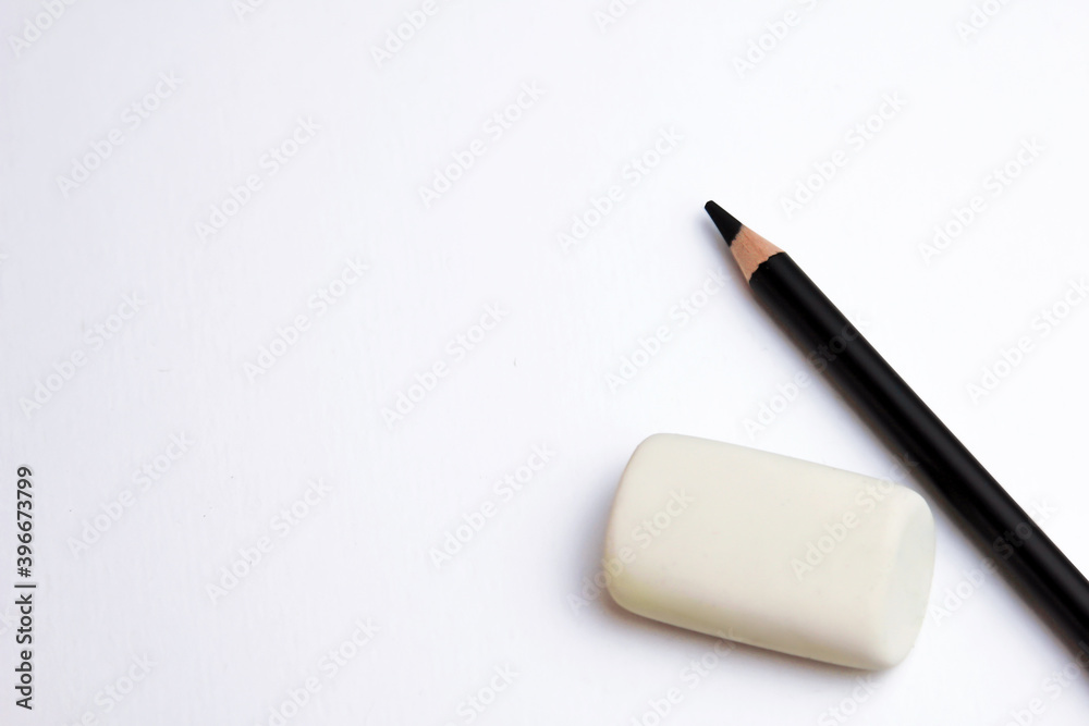 black pencils on a white background with an elastic band black pencils on a white background with an elastic band