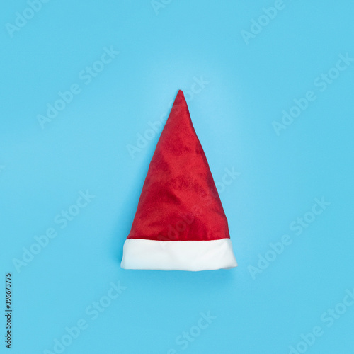 Santa Claus hat on blue background. Minimal Christmas concept. Happy New Year card