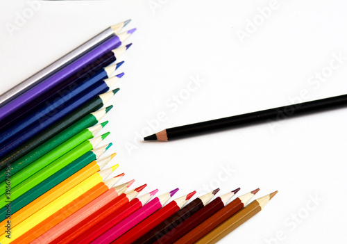 colored pencils and black pencil on a white background