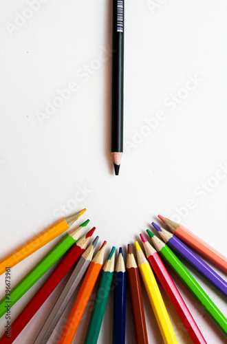 colored pencils and black pencil on a white background