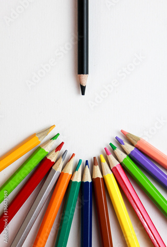 colored pencils and black pencil on a white background