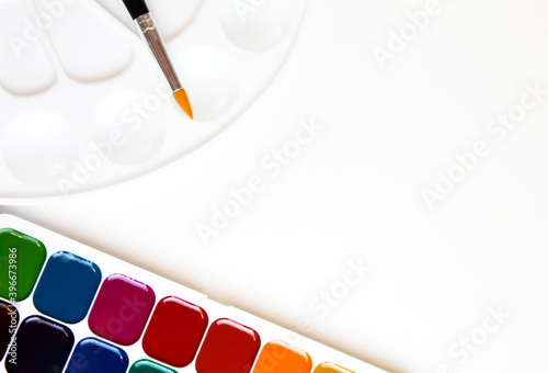 watercolor paints palette and brushes  on a white background