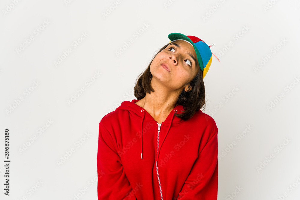Young hispanic woman wearing a cap with propeller isolated dreaming of achieving goals and purposes Young hispanic woman wearing a cap with propeller isolated dreaming of achieving goals and purposes