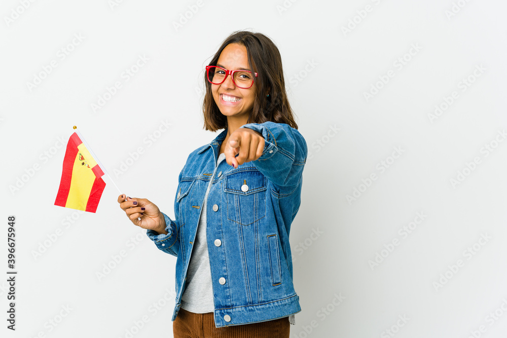 Young spanish woman holding a flag isolated on white background Young spanish woman holding a flag isolated on white background