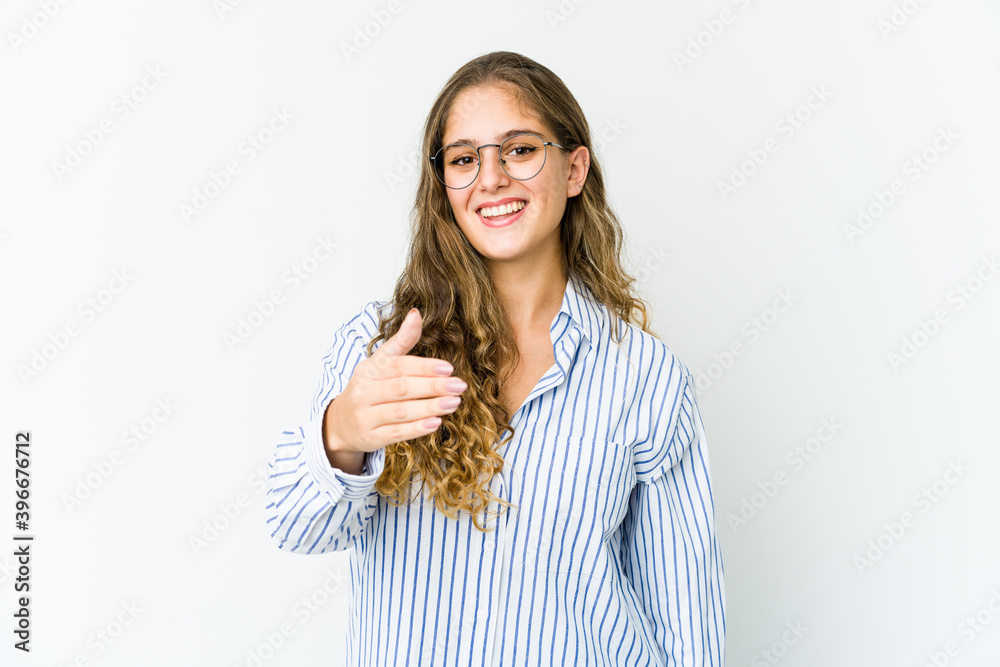 Young caucasian woman stretching hand at camera in greeting gesture. Young caucasian woman stretching hand at camera in greeting gesture.
