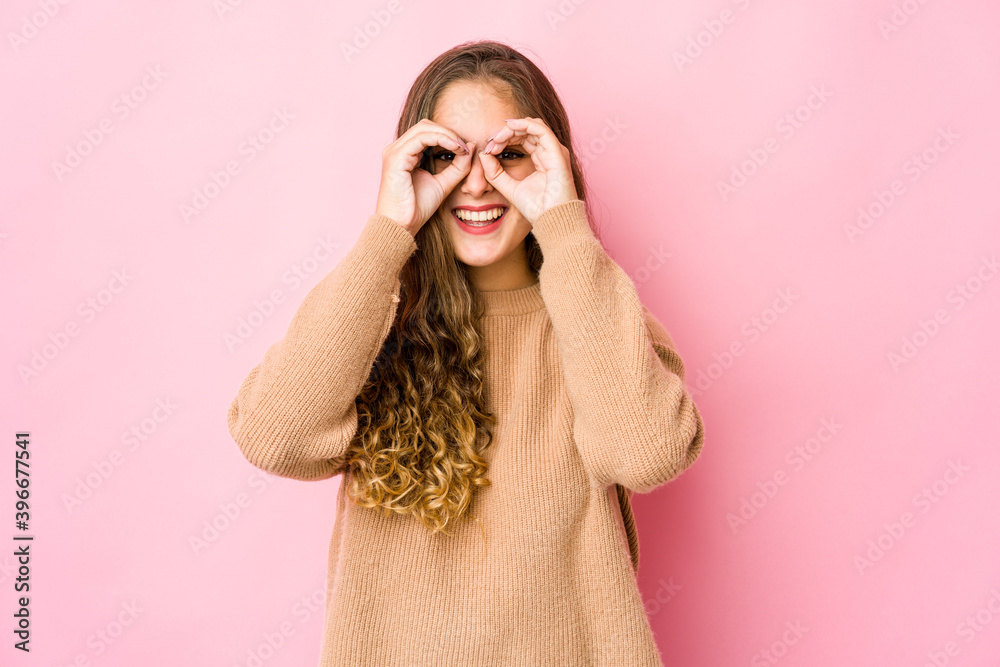 Young caucasian woman showing okay sign over eyes Young caucasian woman showing okay sign over eyes