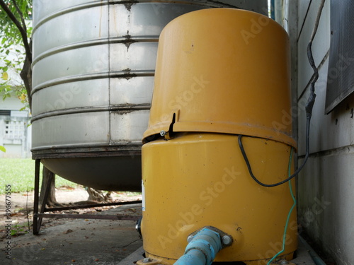old automatic water pump and water tank at home.