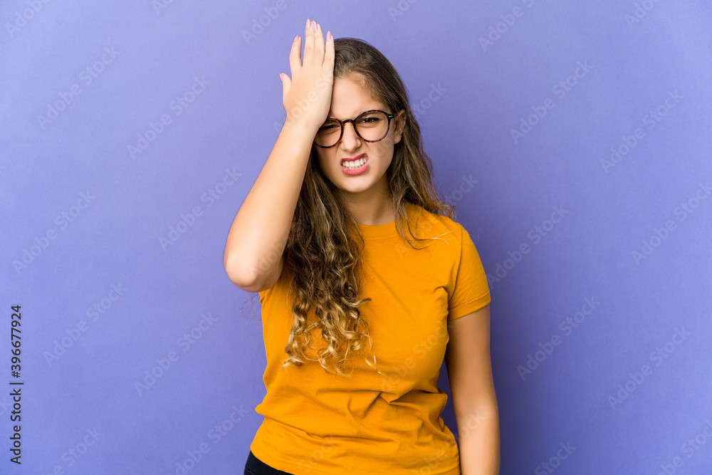 Young caucasian cute woman forgetting something, slapping forehead with palm and closing eyes.