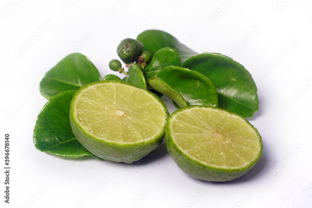 Kaffir Lime or Citrus hystrix. Some are whole, some have been sliced. Focus selected, white background Kaffir Lime or Citrus hystrix. Some are whole, some have been sliced. Focus selected, white background