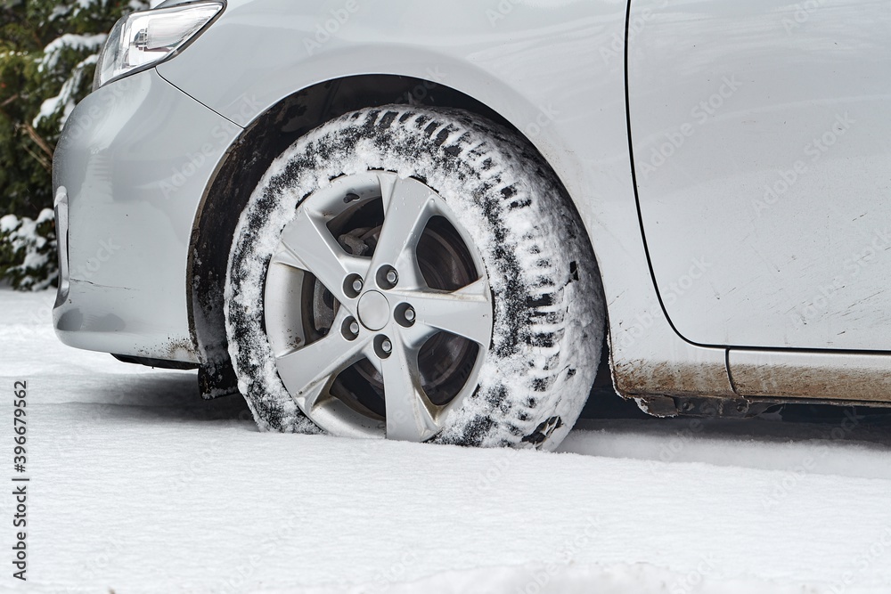 Trails of car wheels in fresh snow