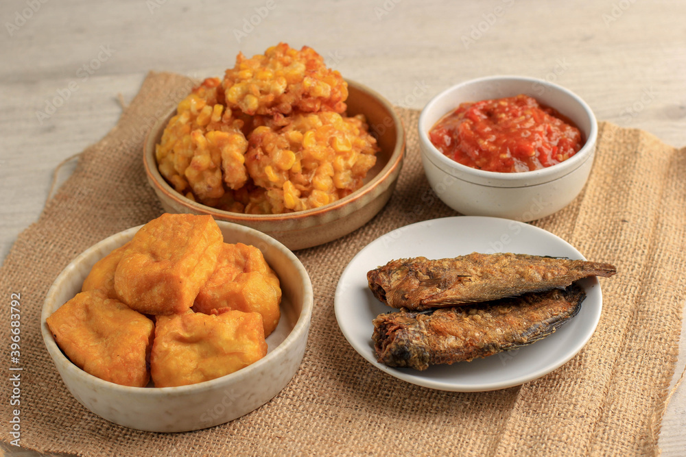 Indonesian Popular Daily Side Dish, Salted Fish, Sambal, Fried Tofu, Cucumber, and Corn Fritter. This Dish Usually find in Warung Nasi tegal (warteg) Indonesian Popular Daily Side Dish, Salted Fish, Sambal, Fried Tofu, Cucumber, and Corn Fritter. This Dish Usually find in Warung Nasi tegal (warteg)